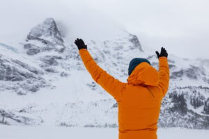 Man hiking in snow. Canadian Nature Landscape